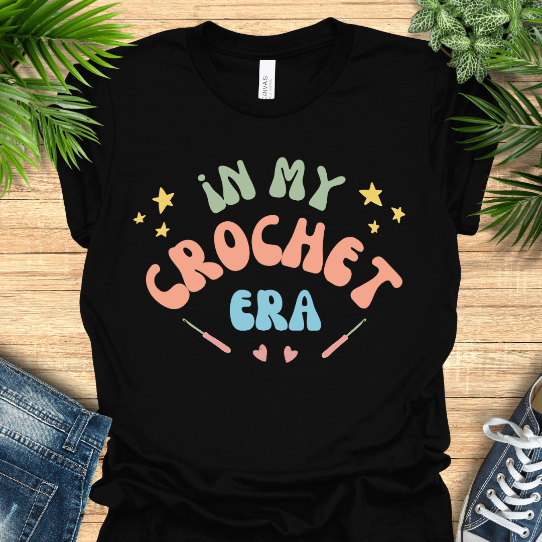 Crochet t-shirt with pastel text "In My Crochet Era", with stars and hearts, perfect for crochet fans.