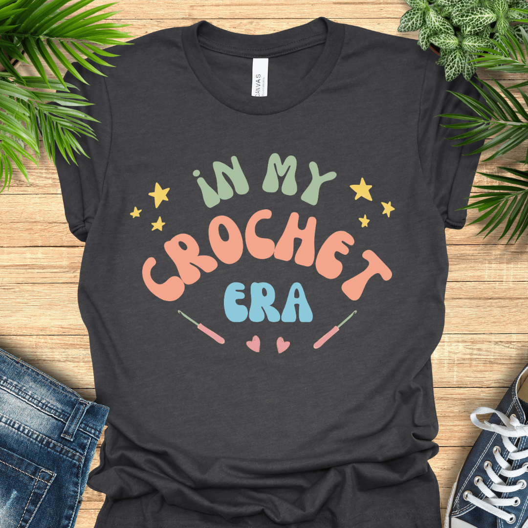 Crochet t-shirt with pastel text "In My Crochet Era", with stars and hearts, perfect for crochet fans.