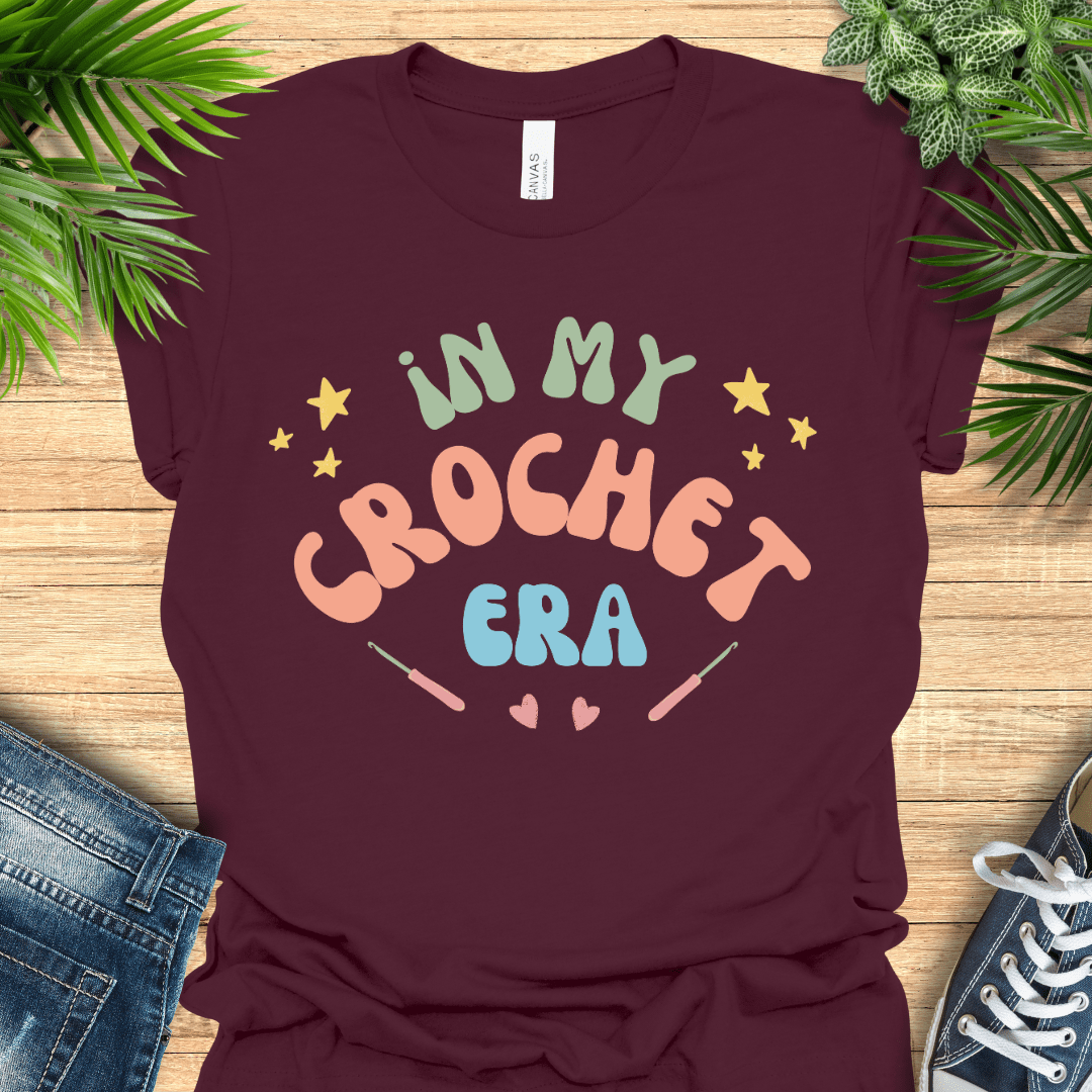 Crochet t-shirt with pastel text "In My Crochet Era", with stars and hearts, perfect for crochet fans.