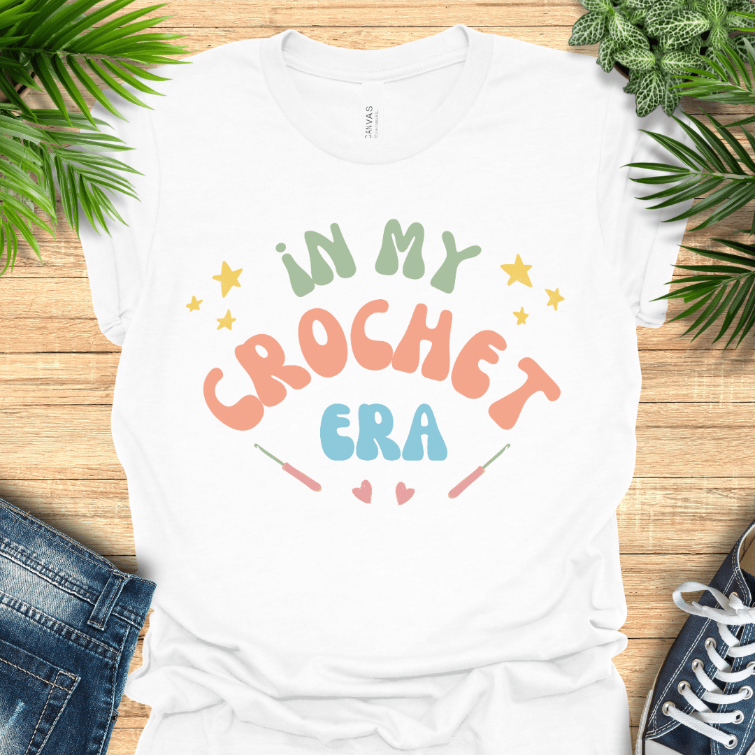 Crochet t-shirt with pastel text "In My Crochet Era", with stars and hearts, perfect for crochet fans.