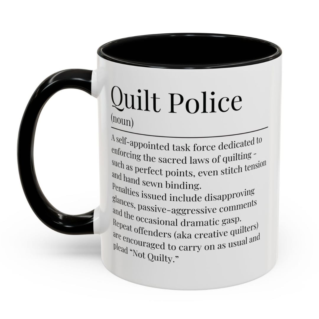 White ceramic mug with black handle featuring a humorous 'Quilt Police' definition – a perfect gift for quilters with a sense of humour.
