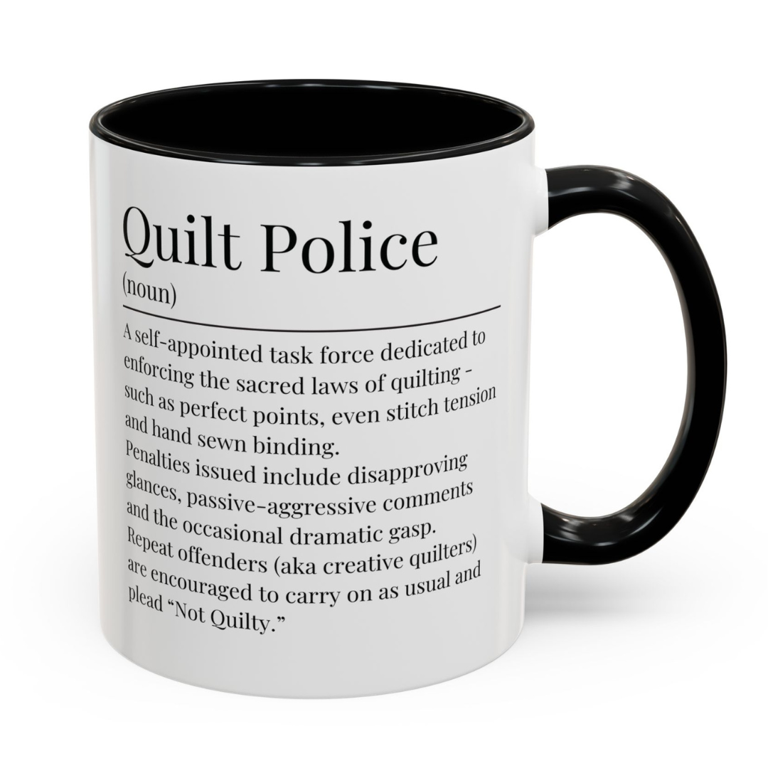 White ceramic mug with black handle featuring a humorous 'Quilt Police' definition – a perfect gift for quilters with a sense of humour.