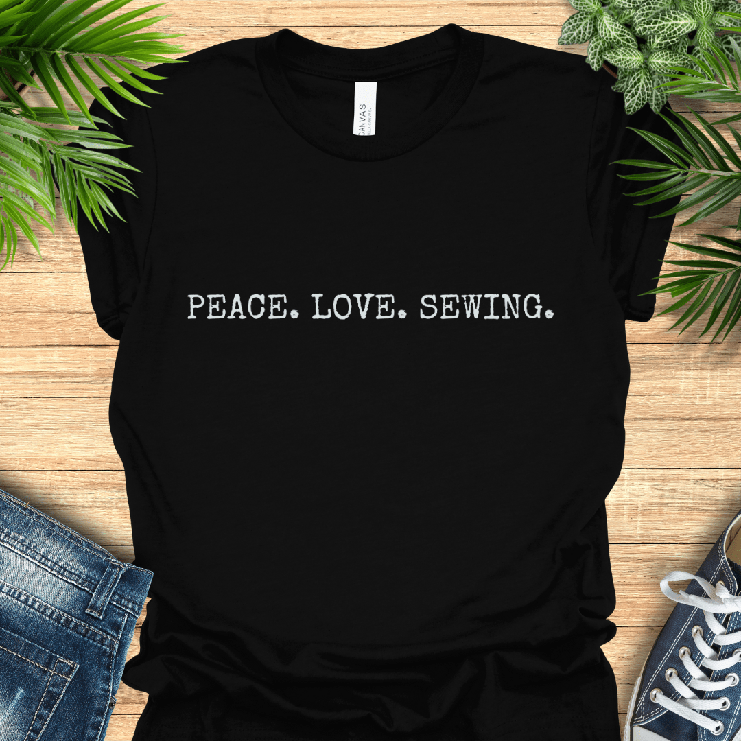 Minimalist sewing t-shirt with ‘PEACE. LOVE. SEWING’ slogan in simple text. Perfect gift for sewists and sewing lovers.