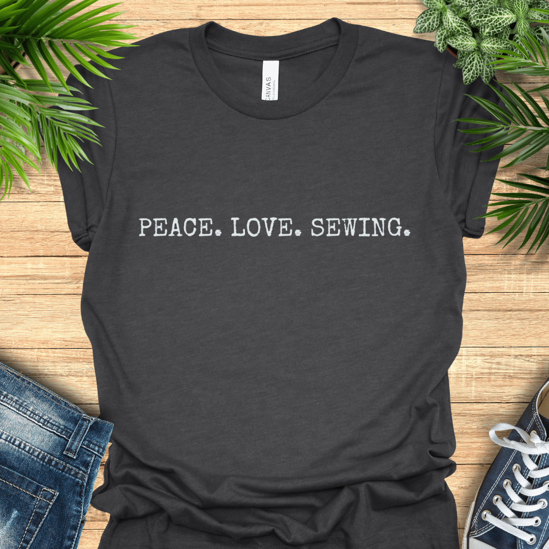 Minimalist sewing t-shirt with ‘PEACE. LOVE. SEWING’ slogan in simple text. Perfect gift for sewists and sewing lovers.