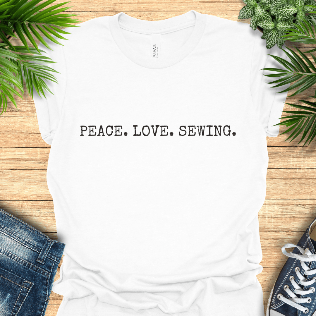 Minimalist sewing t-shirt with ‘PEACE. LOVE. SEWING’ slogan in simple text. Perfect gift for sewists and sewing lovers.