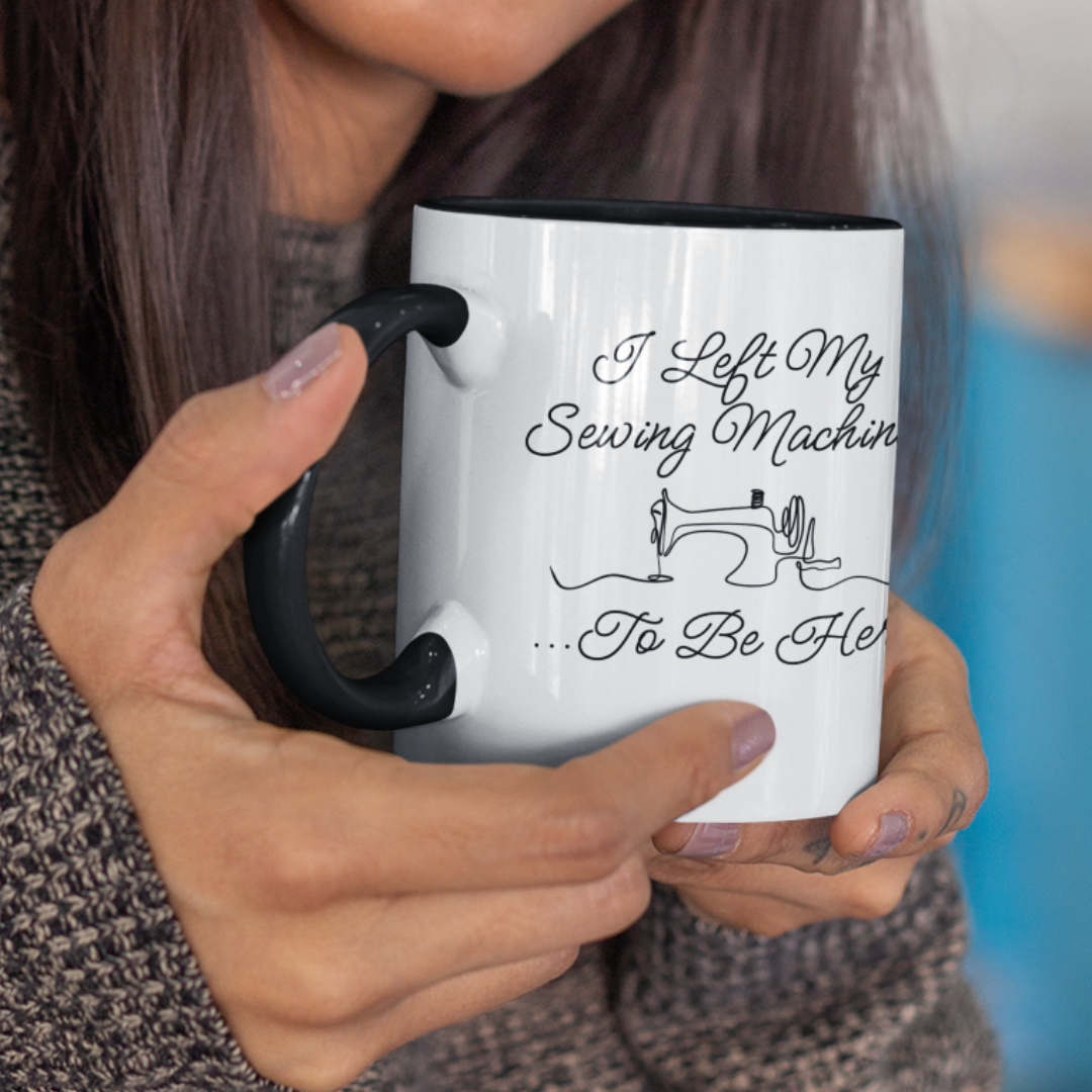 Person holding a mug with a sewing-themed design and text.